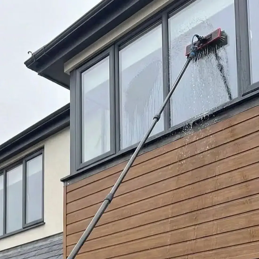 Pure water pole cleaning an upstairs window on a house in Wickford
